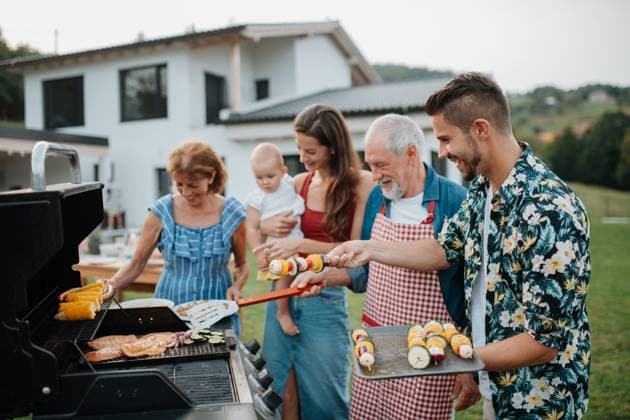 Three generations of family preparing food for a spring weekend barbecue. Three generations of family preparing food for a spring weekend barbecue. Garden party. model released