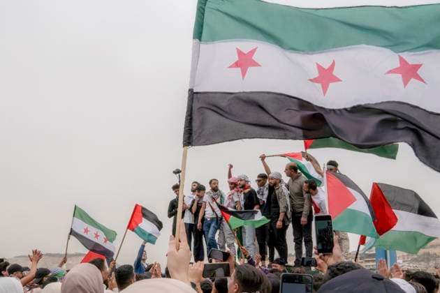 Syrians Against the Occupation Protest People wave the flag of Palestine and the new flag of Syria as Syrians gather in a protest dubbed Syrians Against the Occupation to denounce Israel s continued war on Gaza as well as its occupation of parts of Syria and Palestine in Damascus, Syria, on April 7, 2025. Damascus Damascus Syria Copyright: xAnaghaxSubhashxNairx