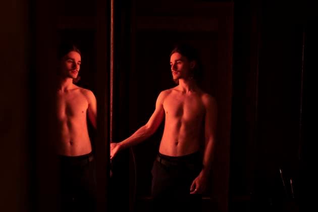 Creative Highlights Symbolfotos Shirtless Young Man Looking at His Reflection in Warm Indoor Light R_ALLI250407A-1699503-01 ,model released, Symbolfoto