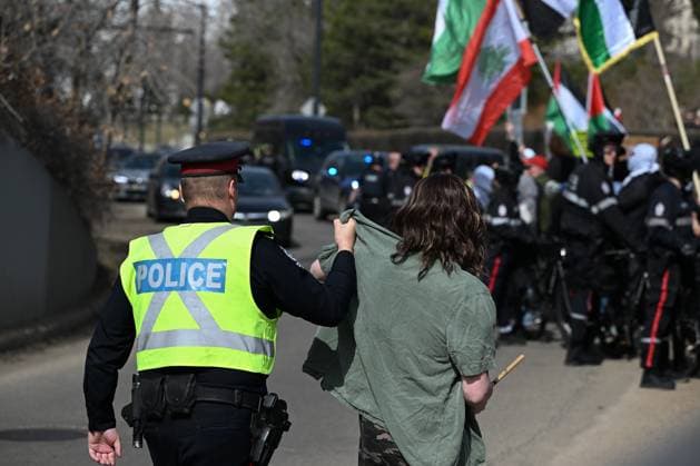 Demonstrators And Police Clash During Palestinian Solidarity Rally In Edmonton EDMONTON, CANADA APRIL 13 Members of the Edmonton Police holds an Edmonton Police stop an activist blocking the vehicle lanes of the High Level Bridge as protesters attempt to disrupt traffic during the Stop the Genocide rally in Edmonton, Alberta, Canada. The demonstration was held in solidarity with Palestinians amid growing demands for a ceasefire and international efforts to address the humanitarian crisis. Edmonton Canada  Copyright: xArturxWidakx originalFilename: widak-demonstr250413_npTK0.jpg