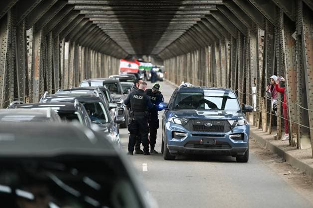 Demonstrators And Police Clash During Palestinian Solidarity Rally In Edmonton EDMONTON, CANADA APRIL 13 An activist is arrested as Edmonton Police attempt to push protesters off the vehicle lanes of the High Level Bridge and clear the way for traffic during the Stop the Genocide rally in Edmonton, Alberta, Canada, on April 13, 2025. The demonstration was held in solidarity with Palestinians amid growing demands for a ceasefire and international efforts to address the humanitarian crisis. Edmonton Canada  Copyright: xArturxWidakx originalFilename: widak-demonstr250413_npYnY.jpg