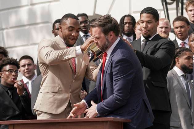 Ohio State University football player TreVeyon Henderson, left, catches the top of the team s championship trophy after Vice President JD Vance tries to pick it up when President Trump welcomed the 2025 College Football National Champions - The Ohio State University on the South Lawn of the White House in Washington, DC on Monday, April 14, 2025.  WAS20250414577 KenxCedeno