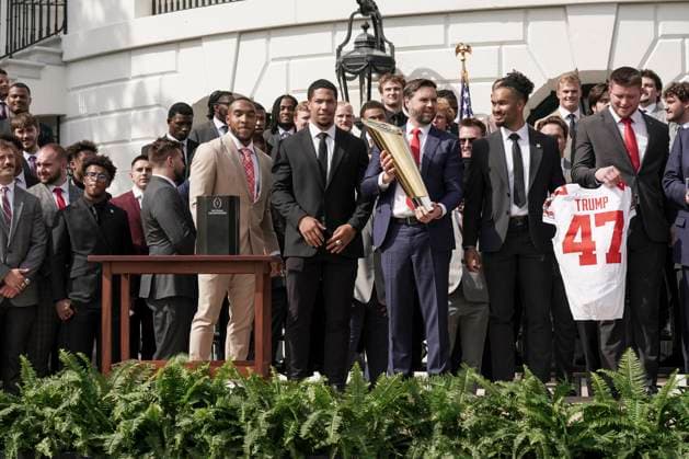 Vice President JD Vance holds the top of the team trophy after he dropped the base while the 2025 College Football National Champions - The Ohio State University visited on the South Lawn of the White House in Washington, DC on Monday, April 14, 2025.  WAS20250414583 KenxCedeno