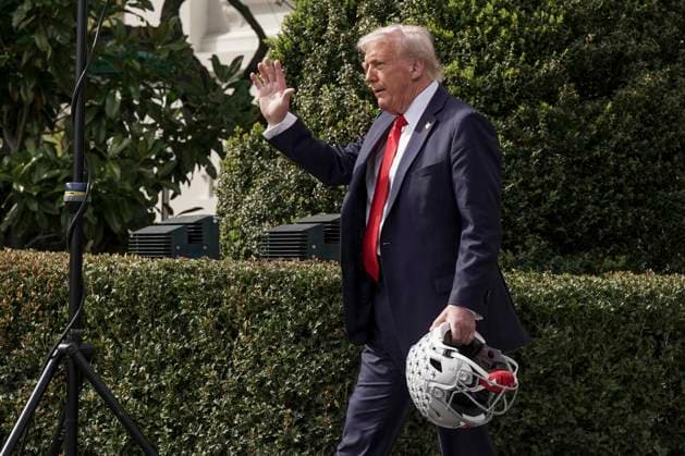U.S. President Donald Trump waves after welcoming the 2025 College Football National Champions, Ohio State University on the South Lawn of the White House in Washington, DC on Monday, April 14, 2025.  WAS20250414592 KenxCedeno