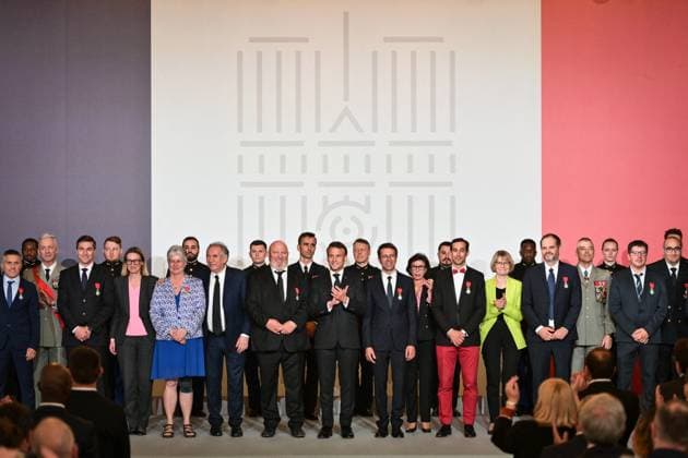 Emmanuel Macron awards those involved in Notre Dame de Paris Cathedral restorations - FA French President Emmanuel Macron poses for a photo after awarding those involved in the restorations of Notre-Dame de Paris Cathedral at the Elysee Palace in Paris on April 15, 2025. Photo by Firas Abdullah ABACAPRESS.COM Paris Ile-de-France France  Copyright: xAbdullahxFiras ABACAx
