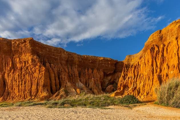 Felsformation an einer Kies- und Sandküste. Rote Klippen mit erstaunliche Formationen am Sandstrand. Praia da Falésia, Algarve, Portugal Incredible rock formation on a pebble and sand coast. Red cliffs with red soil and amazing formations on the sandy beach. Praia da Falésia, bathed in warm sunlight, Algarve, Portugal (License=RF) Copyright: xZoonar.com JanxWehnertx 23181300