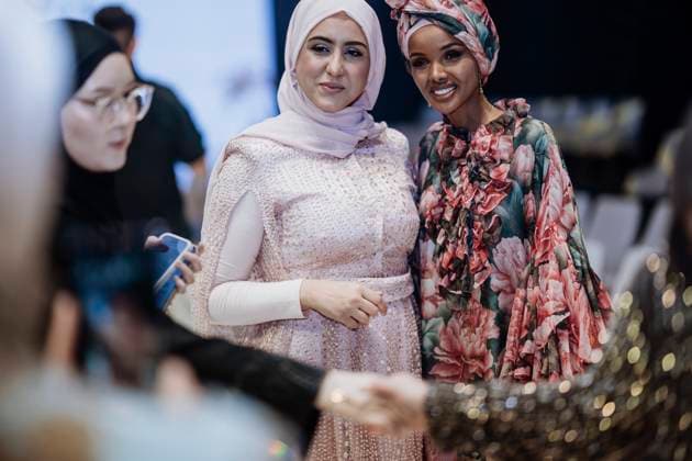 April 15, 2025, Abu Dhabi, United Arab Emirates: Somali model Halima Aden seen with a guest. Turkish brand Imannor presented at the final show of the second day of Abu Dhabi Modest Fashion Week 2025 (14-16 April), organized by Think Fashion at St. Regis Saadiyat Island Resort. Abu Dhabi United Arab Emirates - ZUMAs197 20250415_aaa_s197_617 Copyright: xValeriaxFerrarox