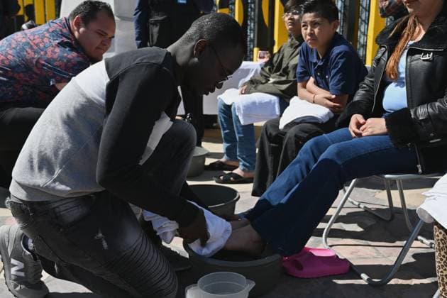 April 17, 2025, Tijuana, Baja California, Mexico: Haitian migrant and volunteer Djephy Wood Denios from La Casa del Migrante in Tijuana, Mexico cleans the feet of a woman during the annual foot washing ceremony where volunteers wash and clean the feet of migrants during a ceremony for holy week in accordance to the twelve apostles remembrance of Jesus Christ Ã¢â‚¬oeFor I have given you an example, that you should do as I have done to youÃ¢â‚¬Â as Father Pat Murphy compares Jesus act to migrants plight and the unfair treatment of migrants and urged for a time of reflection for those seeking the right to freedom of movement and humanitarian asylum on Thursday, April 17, 2025 at TijuanaÃ¢â‚¬â ¢s Friendship Park circle on the US-Mexico border. - ZUMAm180 20250417_zip_m180_010 Copyright: xCarlosxA.xMorenox