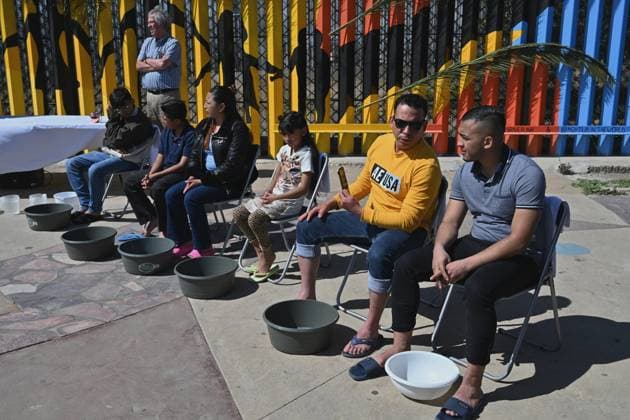 April 17, 2025, Tijuana, Baja California, Mexico: Migrants from La Casa del Migrante in Tijuana, Mexico wait to get their feel washed during the annual foot washing ceremony where volunteers wash and clean the feet of migrants during a ceremony for holy week in accordance to the twelve apostles remembrance of Jesus Christ Ã¢â‚¬oeFor I have given you an example, that you should do as I have done to youÃ¢â‚¬Â as Father Pat Murphy compares Jesus act to migrants plight and the unfair treatment of migrants and urged for a time of reflection for those seeking the right to freedom of movement and humanitarian asylum on Thursday, April 17, 2025 at TijuanaÃ¢â‚¬â ¢s Friendship Park circle on the US-Mexico border. Tijuana Mexico - ZUMAm180 20250417_zip_m180_002 Copyright: xCarlosxA.xMorenox