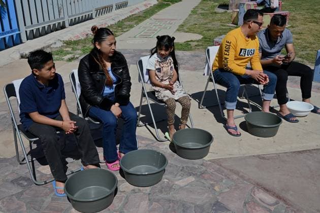 April 17, 2025, Tijuana, Baja California, Mexico: Migrants from La Casa del Migrante in Tijuana, Mexico wait to get their feel washed during the annual foot washing ceremony where volunteers wash and clean the feet of migrants during a ceremony for holy week in accordance to the twelve apostles remembrance of Jesus Christ Ã¢â‚¬oeFor I have given you an example, that you should do as I have done to youÃ¢â‚¬Â as Father Pat Murphy compares Jesus act to migrants plight and the unfair treatment of migrants and urged for a time of reflection for those seeking the right to freedom of movement and humanitarian asylum on Thursday, April 17, 2025 at TijuanaÃ¢â‚¬â ¢s Friendship Park circle on the US-Mexico border. Tijuana Mexico - ZUMAm180 20250417_zip_m180_016 Copyright: xCarlosxA.xMorenox
