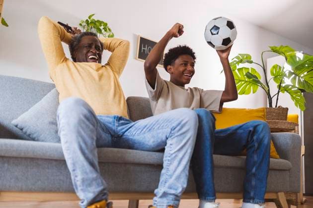 Happy senior man and grandson enjoying match together at home model released, Symbolfoto property released, ALZF00186