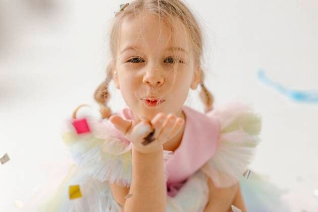 Creative Highlights Symbolfotos Girl in colorful dress blowing confetti during a celebration model released, Symbolfoto property released, VIVF01634