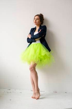Creative Highlights Symbolfotos Woman in a loft wearing a green skirt and blazer, embodying work-life balance and self-realization model released, Symbolfoto property released, KNSF11308