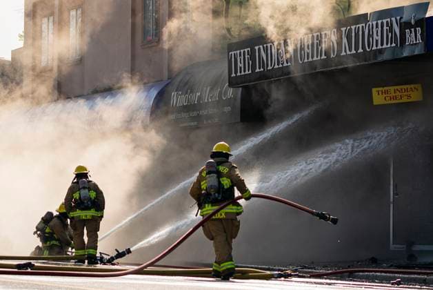 April 23, 2025, Vancouver, Bc, CANADA: A Vancouver firefighter grabs a hose while battling a flare up of a three alarm fire on East Hastings Street in Vancouver, on Wednesday April 23, 2025. Vancouver CANADA  - ZUMAc35_ 20250423_zaf_c35_031 Copyright: xRichxLamx