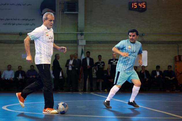 April 25, 2025, Tehran, Iran: Iranian President MASOUD PEZESHKIAN (L) participates in a football match to celebrate Iran Labor Week and honor the laborers of the nation, competing between the workers and veterans teams. Tehran Iran - ZUMAi98_ 20250425_zih_i98_012 Copyright: xIranianxPresidencyx