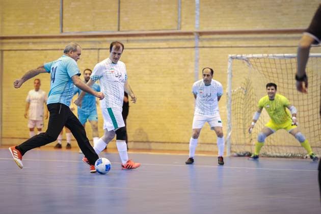 April 25, 2025, Tehran, Iran: Iranian President MASOUD PEZESHKIAN (L) participates in a football match to celebrate Iran Labor Week and honor the laborers of the nation, competing between the workers and veterans teams. Tehran Iran - ZUMAi98_ 20250425_zih_i98_015 Copyright: xIranianxPresidencyx