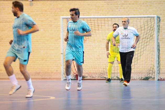 April 25, 2025, Tehran, Iran: Iranian President MASOUD PEZESHKIAN (R) participates in a football match to celebrate Iran Labor Week and honor the laborers of the nation, competing between the workers and veterans teams. Tehran Iran - ZUMAi98_ 20250425_zih_i98_021 Copyright: xIranianxPresidencyx