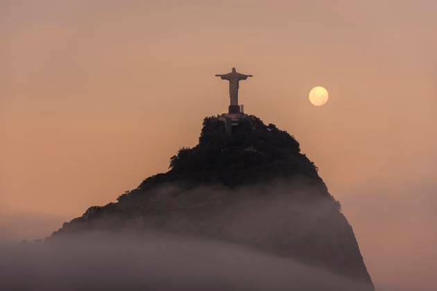Beautiful view to Christ the Redeemer Statue and full moon rising Rio de Janeiro, RJ, Brazil R_GNUJ210511-741628-01 EDITORIAL USE ONLY