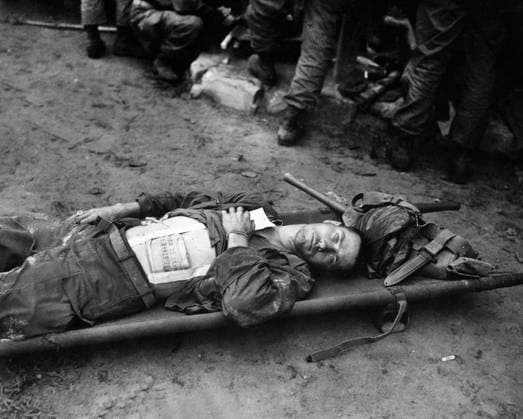 September 19, 1950, South Korea: Private First Class, Thomas Conlon, 21st Infantry Regiment, laying on stretcher at medical aid station, after being wounded while crossing the Nakdong River, South Korea, U.S. Army Signal Corps, September 19, 1950 South Korea - ZUMAg145 19500919_aza_g145_001 Copyright: xJTxVintagex