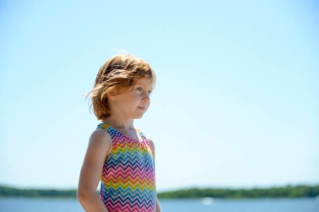 Creative Highlights Symbolfotos Little redhead girl in swimsuit by a lake. Merrifield, MN, United States R_RDOL210428A-729558-01 ,model released, Symbolfoto