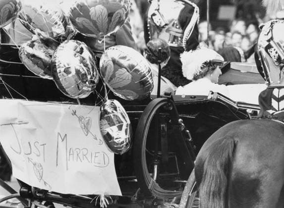 30.07.1981. Prince Charles and Princess Diana sit 30.07.1981. Prince Charles and Princess Diana sit in a an open Royal Carriage on their wedding day. A sign saying Just Married is tacked to the back with balloons.  Copyright: xNotxKnownx