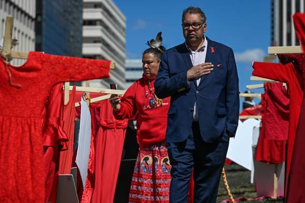Edmonton Marks Red Dress Day To Honour Missing And Murdered Indigenous Women And Girls EDMONTON, CANADA MAY 5: Naheed Nenshi, leader of the Alberta New Democratic Party, walks slowly through a solemn memorial of wooden crosses and red dresses, honouring missing and murdered Indigenous women and girls (MMIWG), outside the Alberta Legislature in Edmonton on May 5, 2025. Red Dress Day is an annual event initiated by the REDress Project to honour the lives of MMIWG across Canada, first observed on May 5, 2010. Edmonton Canada  Copyright: xArturxWidakx originalFilename: widak-edmonton250505_np0AG.jpg