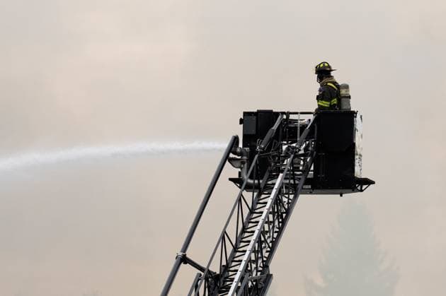 May 10, 2025, North Vancouver, Bc, CANADA: A North Vancouver Fire Department firefighter extinguishes a fire at Silverlynn Apartments, a three-storey seniors housing complex, in North Vancouver, B.C., Saturday, May 10, 2025. North Vancouver CANADA  - ZUMAc35_ 20250510_zaf_c35_036 Copyright: xEthanxCairnsx