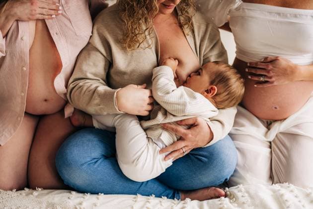 IMAGO Creative, Diversity, Mütter Mother breastfeeding baby seated between two pregnant women North Andover, Massachusetts, United States CR_FKNH250507A-1659427-01 ,model released, Symbolfoto