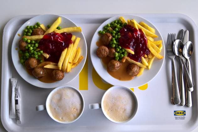 Ikea Food Restaurant Two plates with Köttbullar, fries and peas, and two cappuccinos in a cup on a food tray