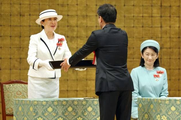 Japan Empress Masako at Red Cross event Japanese Empress Masako (L) hands out awards to people who have contributed to the Japanese Red Cross Society s activities during the body s event in Tokyo on May 13, 2025. (Pool photo)  A14AA0004538208P