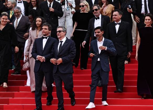 (250519) -- CANNES, May 19, 2025 -- Brazilian director Kleber Mendonca Filho (front C), Brazilian actor and producer Wagner Moura (front L) and cast members leave after the screening of the film The Secret Agent at the 78th edition of the Cannes Film Festival in Cannes, southern France, on May 18, 2025. ) FRANCE-CANNES-FILM FESTIVAL-THE SECRET AGENT-SCREENING GaoxJing 