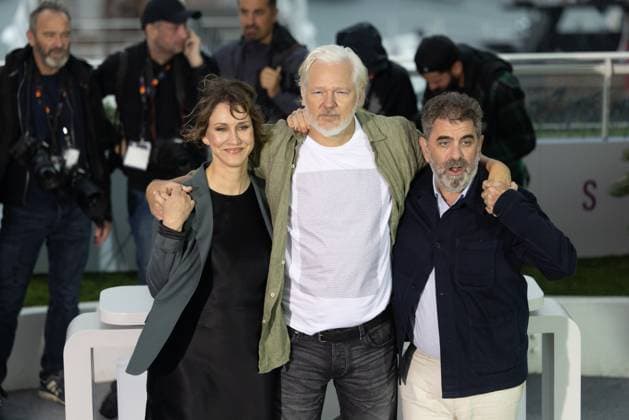 78. Internationalen Filmfestspiele von Cannes 2025 Cannes, Frankreich - 20.5.2024: Kathleen Fournier und Eugene Jarecki stehen neben Julian Assange, welcher ein T-Shirt unter seinem Hemd trägt, auf welchem auf der Vorderseite Namen stehen von Menschen, die in Gaza getötet worden sind sowie auf der Rückseite - Stop Israel - während des - The Six Billion Dollar Man - Photocalls während der 78. Internationalen Filmfestspiele von Cannes. Die 78. Internationalen Filmfestspiele von Cannes finden vom 13. bis 24. Mai 2025 statt. Provence-Alpes-Cote d Azur