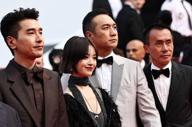 (250525) -- CANNES, May 25, 2025 -- Cast members of the Chinese film Resurrection pose upon their arrival at the red carpet of the closing ceremony of the 78th Cannes Film Festival in Cannes, France, May 24, 2025. Chinese director Bi Gan won on Saturday the Special Award at the 78th Cannes Film Festival for his epic fiction feature Resurrection, known in Chinese as Kuang Ye Shi Dai. Festival organizers introduced Resurrection as a work that showcases the continued evolution of Bi s creativity, while staying true to the sensory and poetic qualities that define his unique cinematic style. ) FRANCE-CANNES-FILM FESTIVAL-CHINESE DIRECTOR-SPECIAL AWARD GaoxJing 