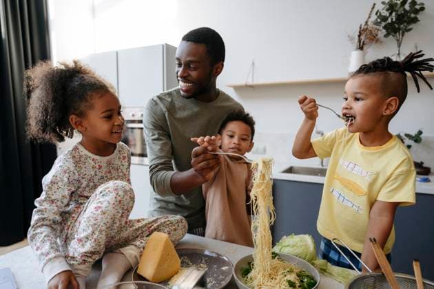 Family enjoying spaghetti in kitchen model released, Symbolfoto property released, VYF00633