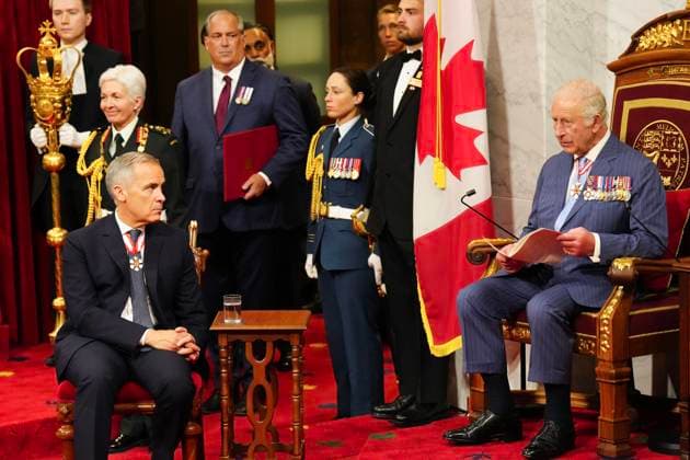 May 27, 2025, Ottawa, On, Canada: Prime Minister Mark Carney, left, looks on as King Charles delivers the speech from the throne in the Senate in Ottawa on Tuesday, May 27, 2025. Ottawa Canada  - ZUMAc35_ 20250527_zaf_c35_091 Copyright: xChrisxYoungx