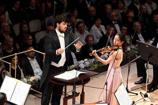 Japanese violinist Tsukushi Sasaki, right, performs at the Prague Radio Symphony Orchestra concert under Czech conductor Jan Sedlacek, left, during the Prague Spring International Music Festival on 28 May 2025, Prague, Czech Republic. (CTKxPhoto KaterinaxSulova) CTKPhotoP2025052809816  CTKPhotoP2025052809816