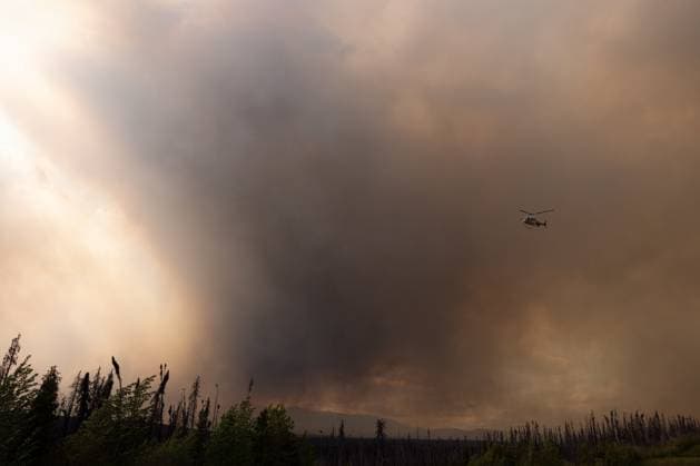 May 30, 2025, Buckinghorse River, Bc, Canada: Wildfire smoke is seen on Highway 97 as a helicopter flies overhead north of Buckinghorse River, B.C. on Friday, May 30, 2025. Buckinghorse River Canada  - ZUMAc35_ 20250530_zaf_c35_193 Copyright: xNasunaxStuart-Ulinx