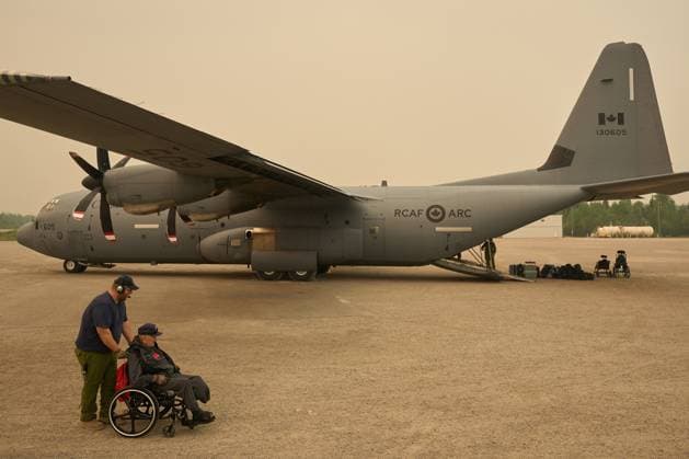 June 3, 2025, Norway House, Mb, CANADA: Royal Canadian Air Force Cpl. David Willis helps evacuate Jacob Muswagon, a resident of the Pinaow Wachi Care home to board a C-130 Hercules aircraft in Norway House, Man., Tuesday, June 3, 2025, at the Norway House Airport as crews continue to fight wildfires in northern Manitoba. Norway House CANADA - ZUMAc35_ 20250603_zaf_c35_044 Copyright: xDavidxLipnowskix
