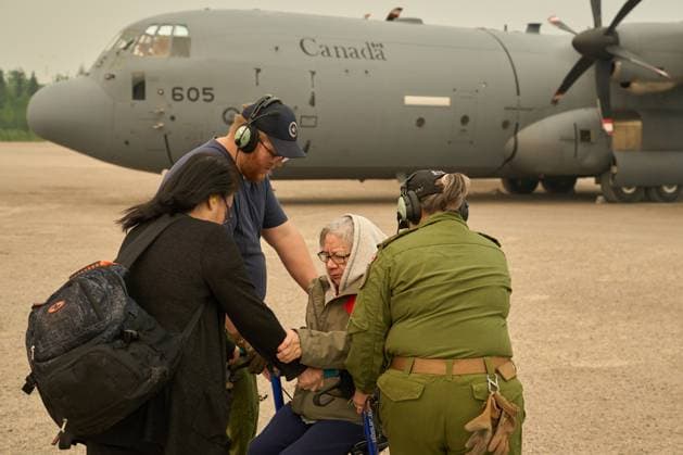 June 3, 2025, Norway House, Mb, CANADA: Royal Canadian Air Force Cpl. David Willis helps evacuate Abbie Duskun (seated) and her daughter Veronica Clarke as they board a C-130 Hercules aircraft in Norway House, Man., Tuesday, June 5, 2025, at the Norway House Airport as crews continue to fight wildfires in northern Manitoba. Norway House CANADA  - ZUMAc35_ 20250603_zaf_c35_059 Copyright: xDavidxLipnowskix