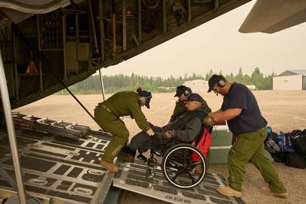 June 3, 2025, Norway House, Mb, CANADA: Members of the Royal Canadian Air Force help evacuate Jacob Muswagon, a resident of the Pinaow Wachi Care home to board a C-130 Hercules aircraft in Norway House, Man., Tuesday, June 3, 2025, at the Norway House Airport as crews continue to fight wildfires in northern Manitoba. Norway House CANADA - ZUMAc35_ 20250603_zaf_c35_062 Copyright: xDavidxLipnowskix