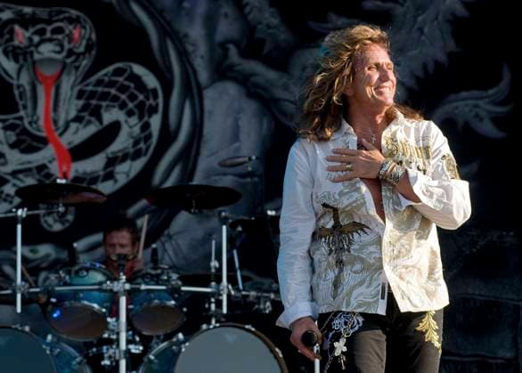 Download Festival 2009 - Day Three WHITESNAKE - DAVID COVERDALE Download Festival 2009 - Day Three Donington Park, Derbyshire, England, Uk, 14th June 2009. concert music gig on stage live performing half length white shirt necklaces chest print hand on smiling bracelets undone CAP BRC Ben Rector Donington Derbyshire Great Britain Copyright: xBenxRector CapitalxPicturesx