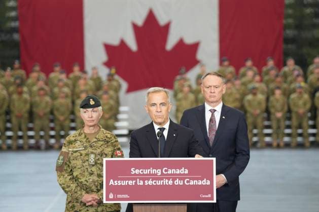 June 9, 2025, Toronto, On, Canada: Prime Minister Mark Carney, centres stands with Minister of National Defence David McGuinty, right, and Chief of the Defence Staff, General Jennie Carignan as he makes an announcement at Fort York Armoury in Toronto before making an announcement on Monday, June 9, 2025. Toronto Canada - ZUMAc35_ 20250609_zaf_c35_050 Copyright: xChrisxYoungx
