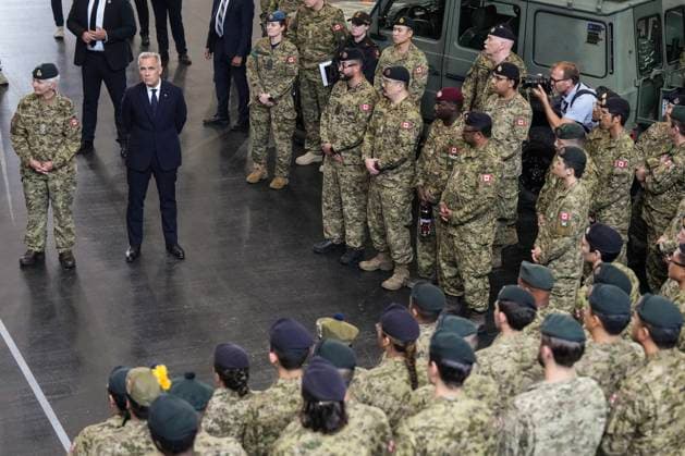 June 9, 2025, Toronto, On, Canada: Prime Minister Mark Carney stands alongside Chief of the Defence Staff, General Jennie Carignan as they talk to service personnel, after a government announcement at Fort York Armoury in Toronto on Monday, June 9, 2025. Toronto Canada  - ZUMAc35_ 20250609_zaf_c35_056 Copyright: xChrisxYoungx