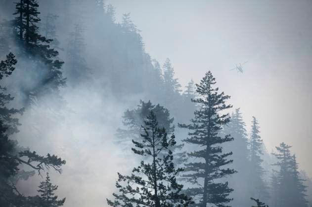 June 11, 2025, Squamish, B.C, CANADA: A helicopter prepares to drop water on the Dryden Creek Wildfire, just north of Squamish, B.C., on Wednesday, June 11, 2025. Squamish CANADA  - ZUMAc35_ 20250611_zaf_c35_059 Copyright: xTijanaxMartinx