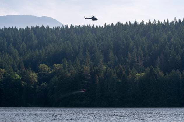 June 11, 2025, Squamish, B.C, CANADA: A helicopter collects water from Alice Lake Provincial Park to help fight the Dryden Creek Wildfire, just north of Squamish, B.C., on Wednesday, June 11, 2025. Squamish CANADA  - ZUMAc35_ 20250611_zaf_c35_065 Copyright: xTijanaxMartinx