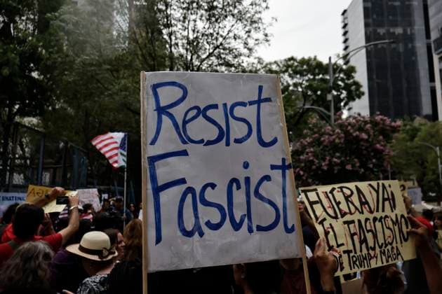 June 14, 2025, Mexico, Cdmx, Mexico: Not only in the Americas are protesting against President Donald Trump, but also abroad, a group of American citizens are taking to the streets of Mexico City toward the United States Embassy to show their disapproval and rejection of the recent violent actions, illegal deportations, and arrests against legal and illegal immigrants in Los Angeles and other sanctuary states. This anti-Trump demonstration is taking place on his birthday, to let him know that he is not a king, that they do not want tyrants, and that they will not celebrate the violence the Trump administration is inflicting on their own people. Mexico Mexico - ZUMAp204 20250614_zip_p204_024 Copyright: xJosuexPerezx