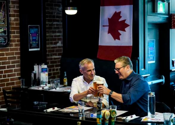 June 14, 2025, Ottawa, On, CAN: Prime Minister of Canada Mark Carney and Prime Minister of the United Kingdom Keir Starmer clink beer glasses as they watch the Edmonton Oilers play the Florida Panthers in the NHL s Stanley Cup Final at a pub in Ottawa, on Saturday, June 14, 2025. Ottawa CAN  - ZUMAc35_ 20250614_zaf_c35_223 Copyright: xJustinxTangx