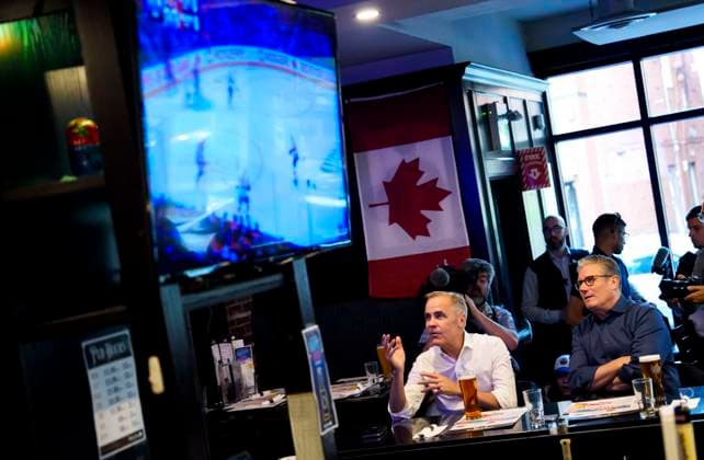 June 14, 2025, Ottawa, On, CAN: Prime Minister of Canada Mark Carney reacts as he watches the Edmonton Oilers play the Florida Panthers in the NHL s Stanley Cup Final with Prime Minister of the United Kingdom Keir Starmer at a pub in Ottawa, on Saturday, June 14, 2025. Ottawa CAN  - ZUMAc35_ 20250614_zaf_c35_227 Copyright: xJustinxTangx