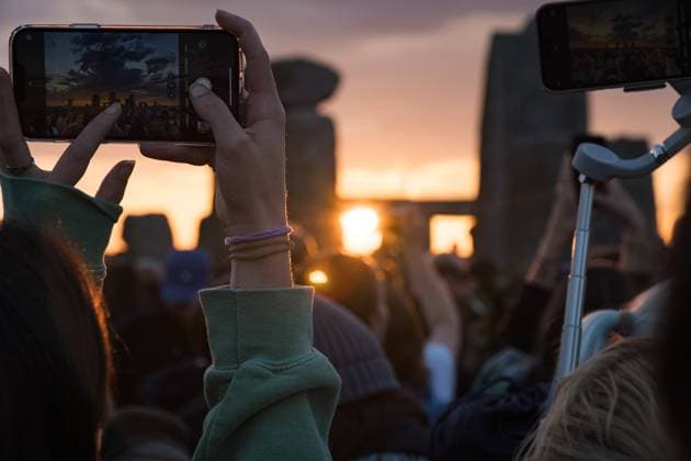 June 21, 2025, Wiltshire, United Kingdom: People seen taking photos of the monuments during sunrise. Thousands of people attended the annual festival and watched sunrise celebrating the summer solstice at Stonehenge which signifies the end of spring. Wiltshire United Kingdom - ZUMAs197 20250621_aaa_s197_584 Copyright: xDanielxLaix