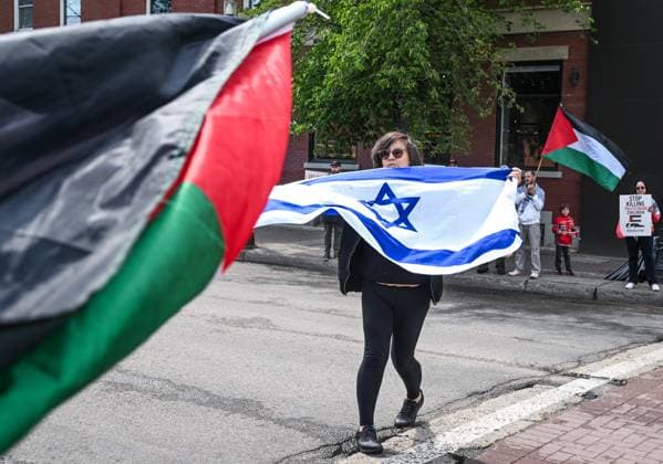 Woman With Israeli Flag Attacked During Edmonton Pro-Palestine Protest EDMONTON, CANADA JUNE 22: A woman carrying an Israeli flag walks away after being physically attacked and having her flag seized earlier by pro-Palestinian and Iranian protesters at the Hands Off Palestine, Iran, Syria, Yemen, Lebanon rally on White Avenue in Edmonton during the demonstration on June 22, 2025, in Edmonton, Alberta, Canada. Edmonton Canada  Copyright: xArturxWidakx originalFilename: widak-womanwit250622_npXZH.jpg